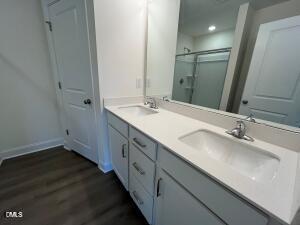 6419 Granite Quarry Drive Raleigh, NC 27610 - Photo 18 of 53 a bathroom with a double vanity sink and mirror