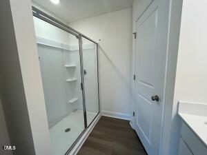 6419 Granite Quarry Drive Raleigh, NC 27610 - Photo 19 of 53 a bathroom with a glass shower door
