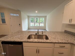6419 Granite Quarry Drive Raleigh, NC 27610 - Photo 5 of 53 a kitchen with granite countertop a sink and a window