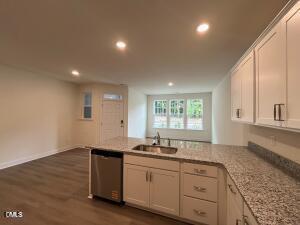6419 Granite Quarry Drive Raleigh, NC 27610 - Photo 7 of 53 a kitchen with granite countertop white cabinets and a sink