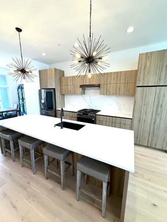 a kitchen with a table a sink and a refrigerator