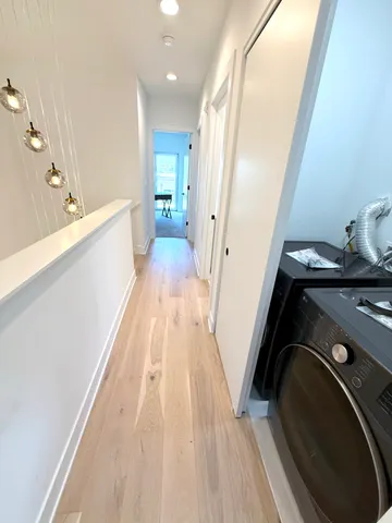 a bathroom with a double vanity sink toilet mirror and bathtub