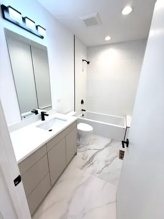 a view of game room with windows and wooden floor