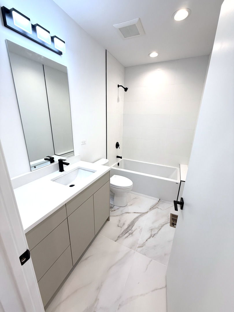 26 Natalie Lane Lake Zurich, IL 60047 - Photo 14 of 18 a bathroom with a double vanity sink toilet mirror and bathtub