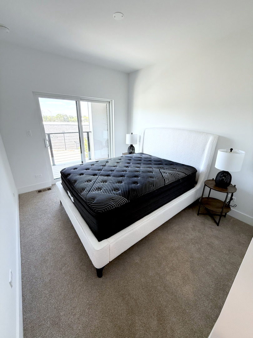 26 Natalie Lane Lake Zurich, IL 60047 - Photo 16 of 18 a bed sitting in a room next to a window