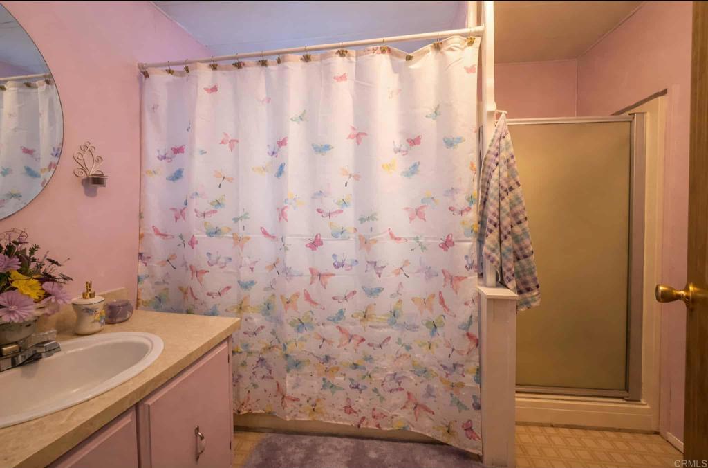 1815 Sweetwater, Unit 1 Spring Valley, CA 91977 - Photo 21 of 34 a bathroom with a sink and a mirror