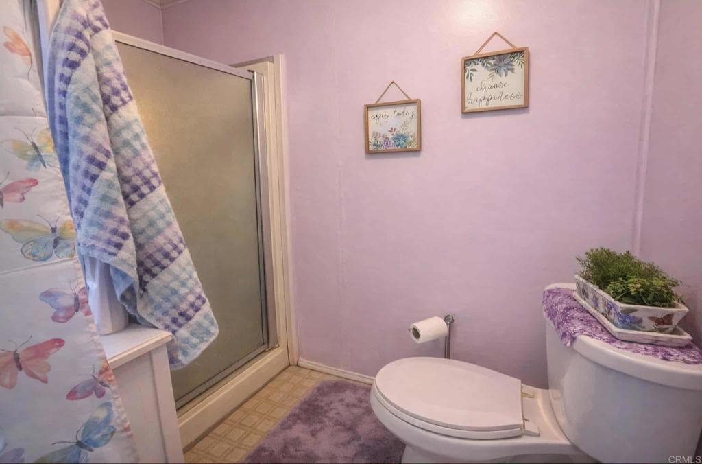 1815 Sweetwater, Unit 1 Spring Valley, CA 91977 - Photo 22 of 34 a white toilet sitting next to a shower curtain