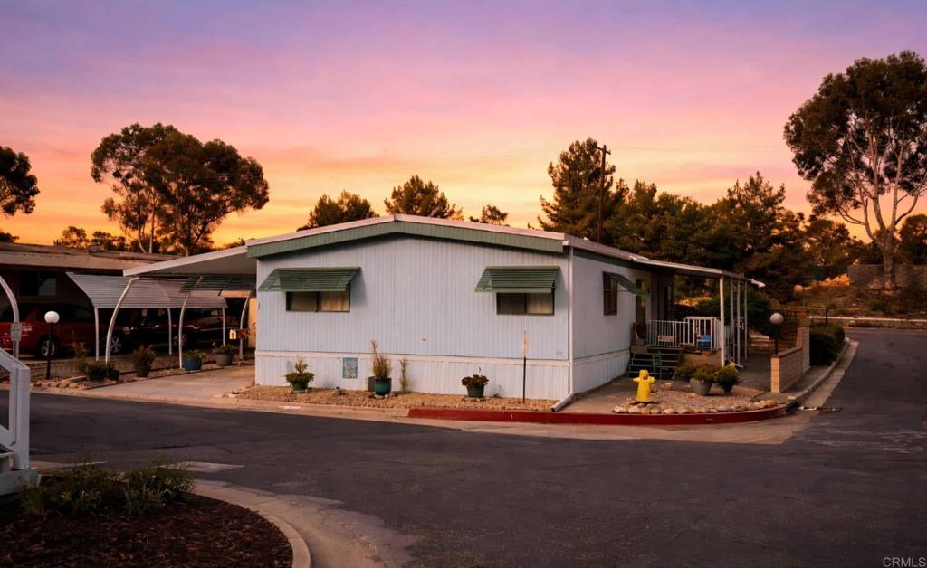 1815 Sweetwater, Unit 1 Spring Valley, CA 91977 - Photo 7 of 34 a view of a white house with a big yard and large tree