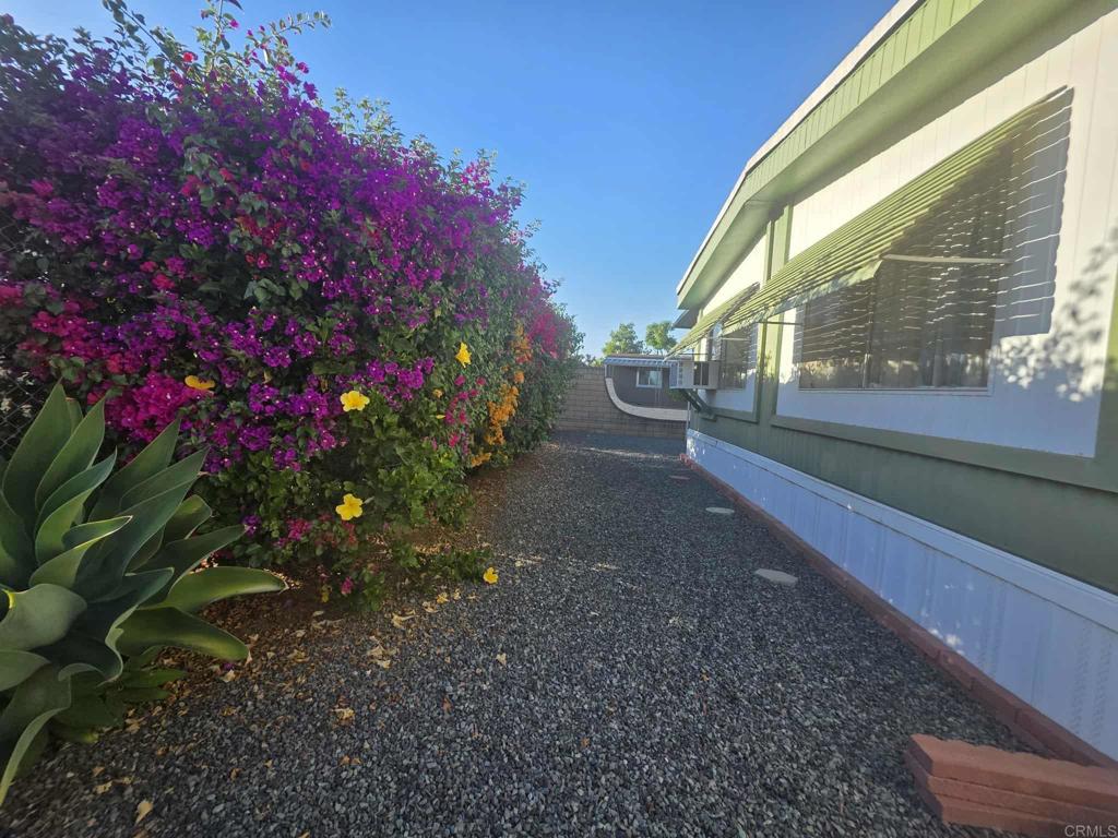 1815 Sweetwater, Unit 1 Spring Valley, CA 91977 - Photo 8 of 34 a view of a pathway with a flower garden