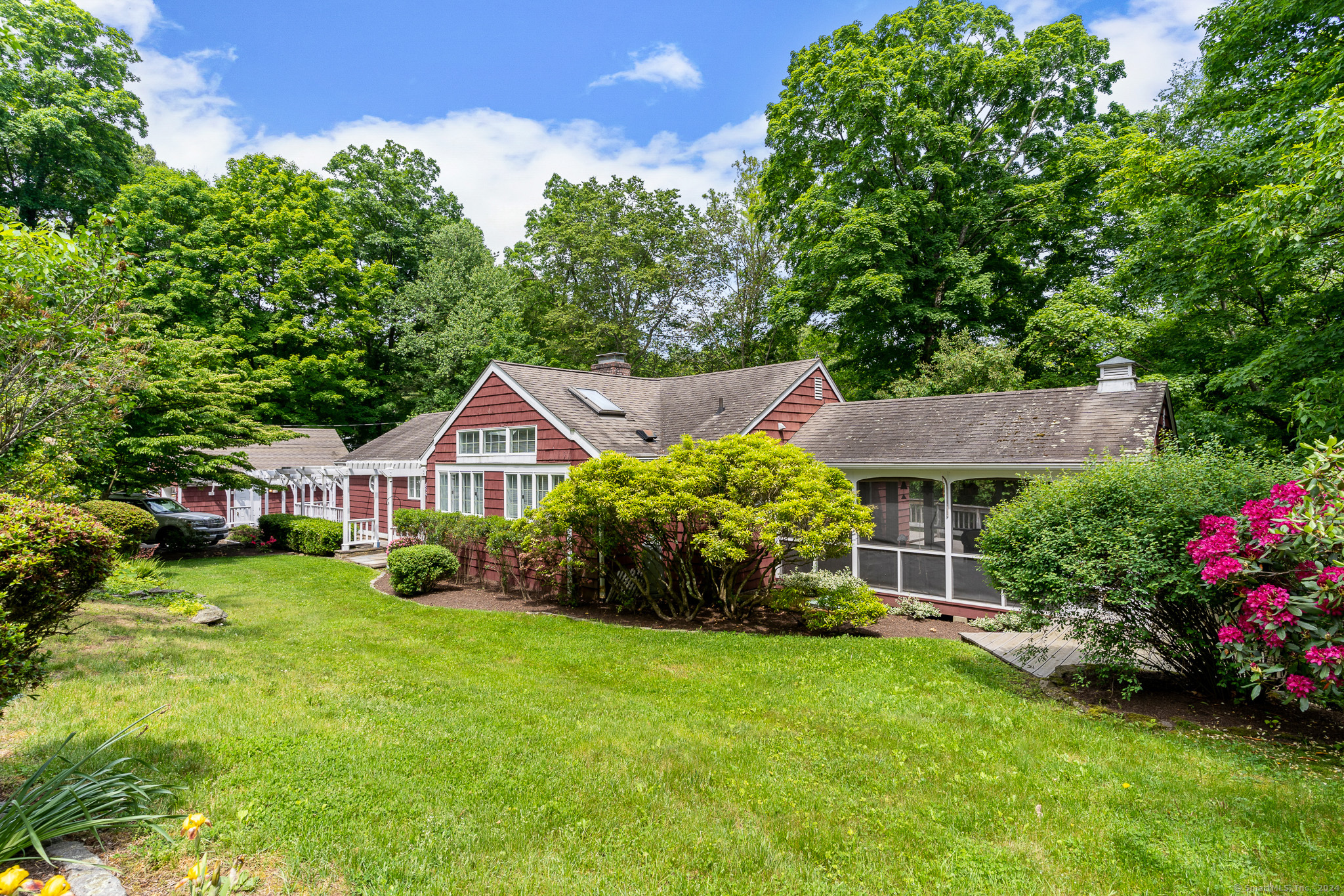 116 Chicken Street Wilton, CT 06897 - Photo 1 of 1 a front view of a house with a garden and trees