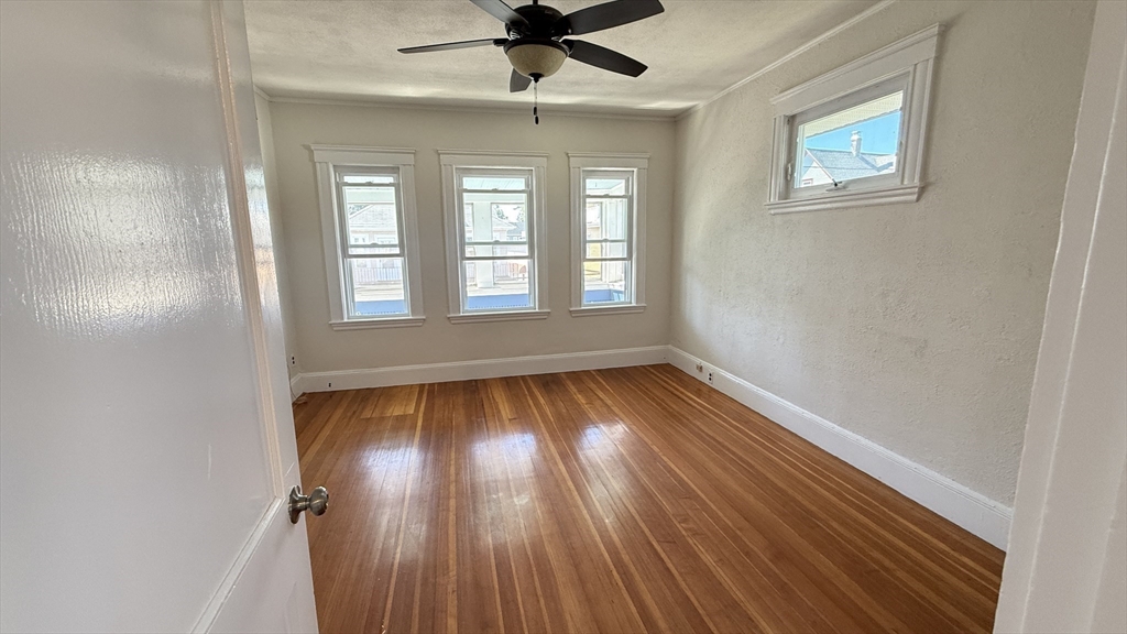 12 Eliot Street, Unit 12 Medford, MA 02155 - Photo 4 of 11 wooden floor in an empty room with a window