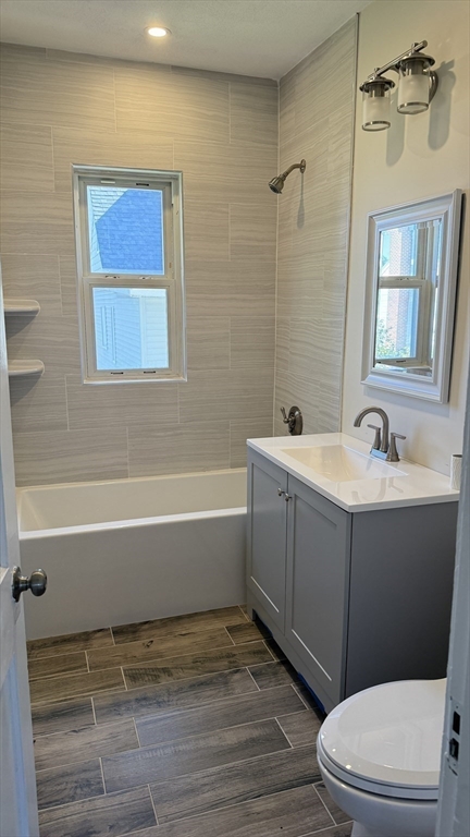 12 Eliot Street, Unit 12 Medford, MA 02155 - Photo 6 of 11 a bathroom with a sink a toilet and shower
