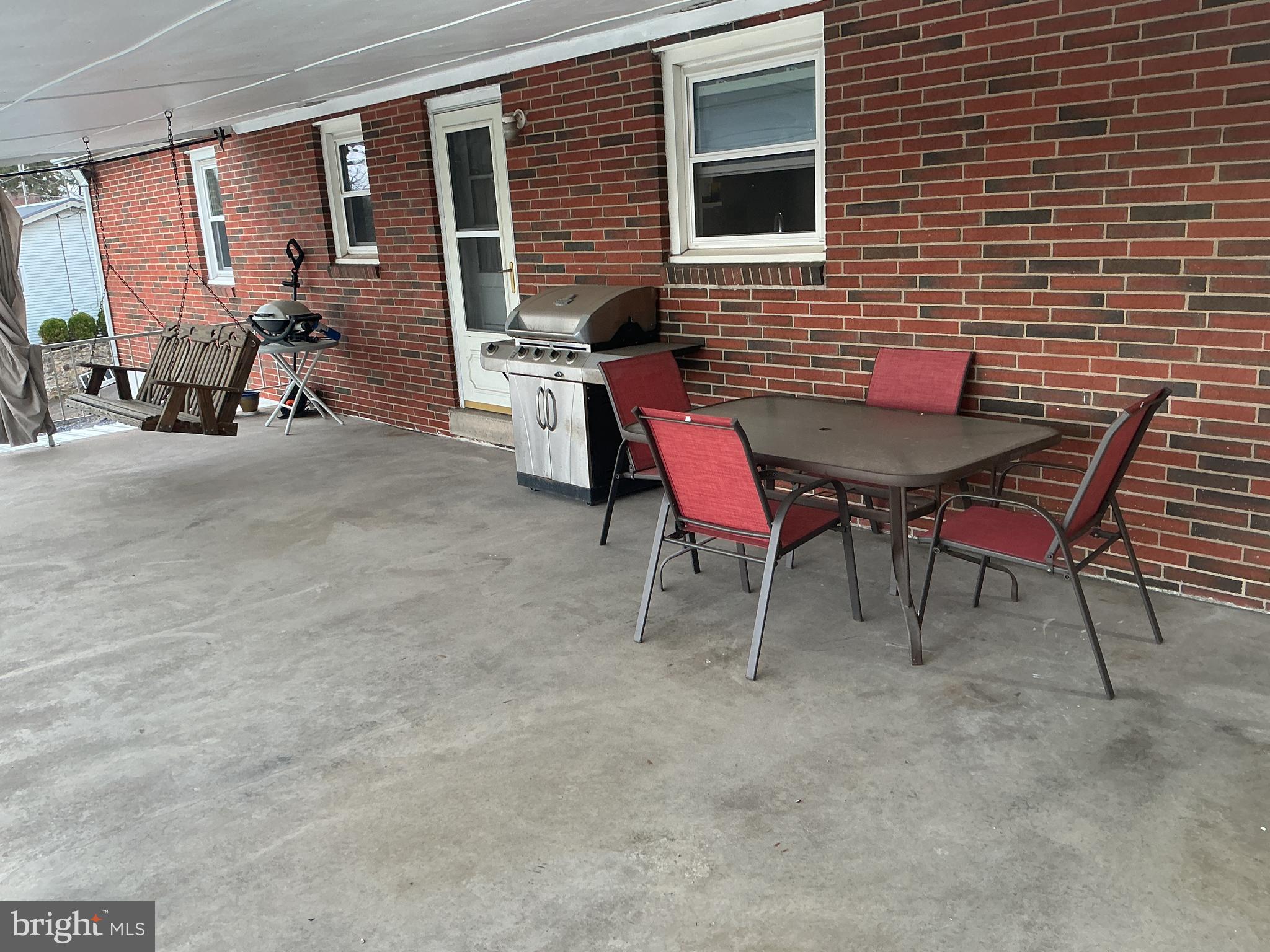 6150 Chambers Hill Road Harrisburg, PA 17111 - Photo 4 of 24 a backyard of a house with table and chairs