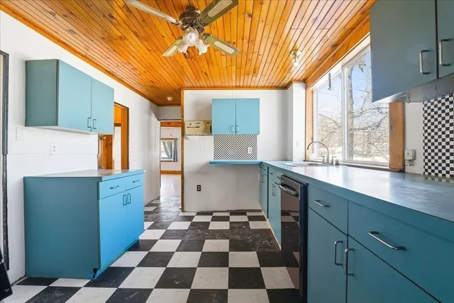 a kitchen with granite countertop stainless steel appliances a sink and a window