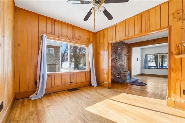 a view of a room with wooden floor and windows