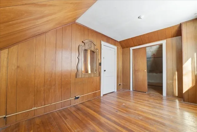 a view of a room with wooden floor and brick walls