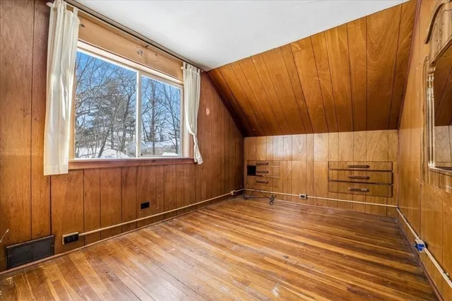 a view of a room with wooden floor and windows