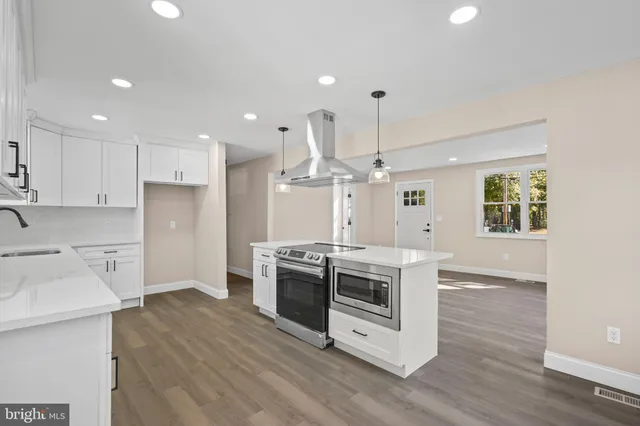 a kitchen with a stove a sink and a refrigerator