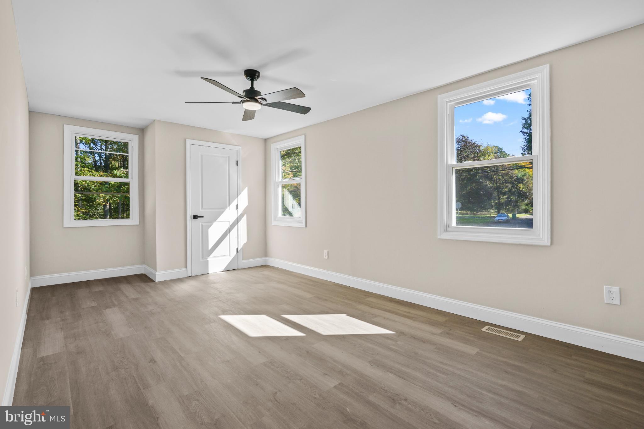 393 East Millstream Road Cream Ridge, NJ 08514 - Photo 14 of 29 a view of an empty room with a window and wooden floor