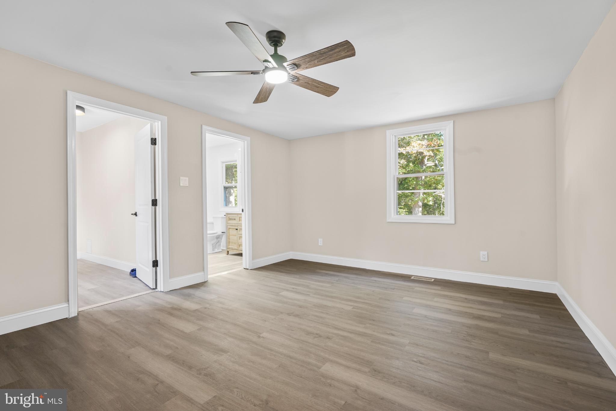 393 East Millstream Road Cream Ridge, NJ 08514 - Photo 16 of 29 a view of an empty room with wooden floor and a window