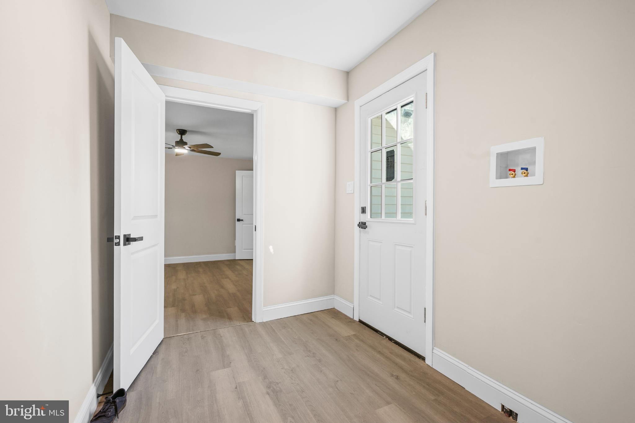 393 East Millstream Road Cream Ridge, NJ 08514 - Photo 19 of 29 an empty room with wooden floor mirror and windows