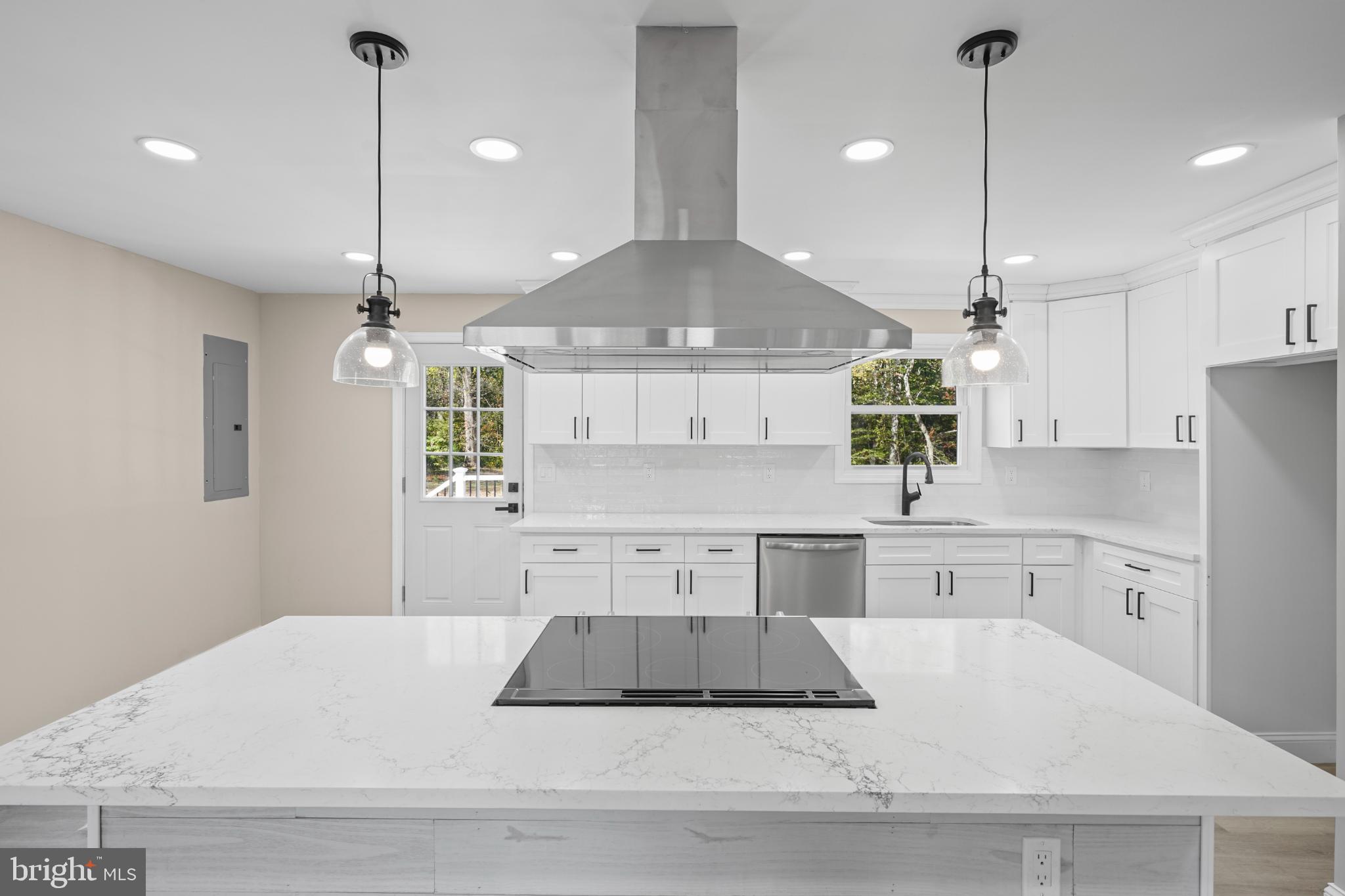 393 East Millstream Road Cream Ridge, NJ 08514 - Photo 10 of 29 a kitchen with kitchen island a counter top space appliances and a ceiling fan