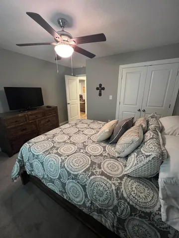 a bedroom with a bed and a chandelier