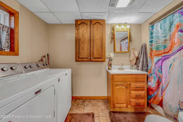 a bathroom with a sink a mirror and a shower curtain