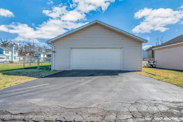 a view of a house with a yard and garage