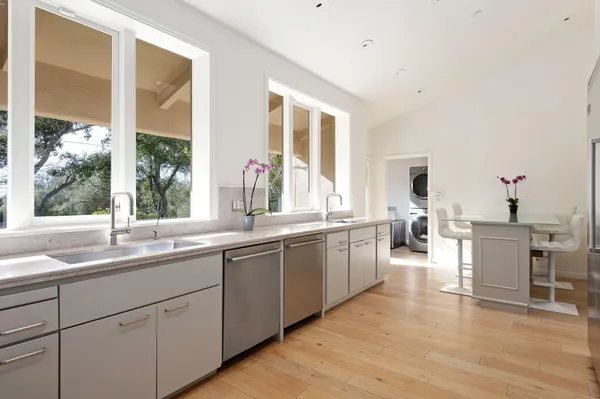 a kitchen with a sink and large window