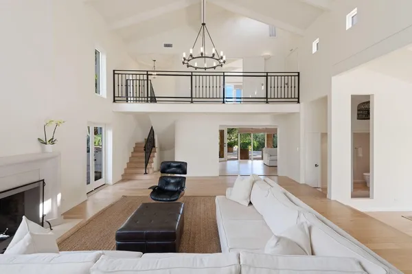 a living room with furniture and large windows