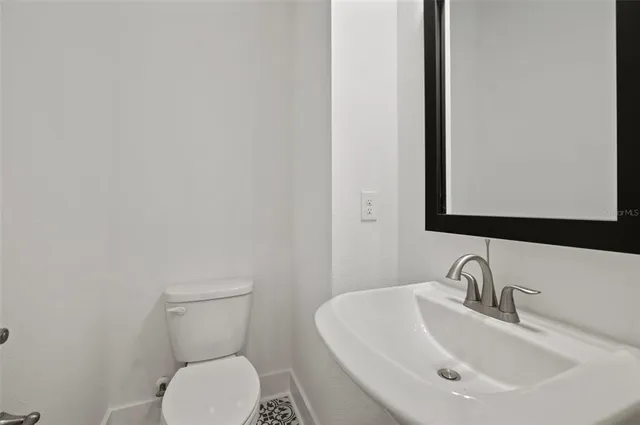 a kitchen with kitchen island white cabinets and stainless steel appliances