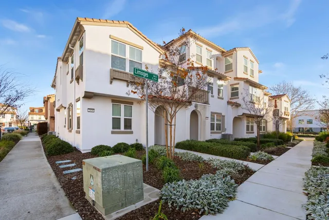 a front view of a residential houses with yard