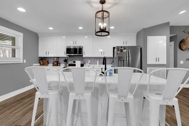 a view of dining room and kitchen with stainless steel appliances
