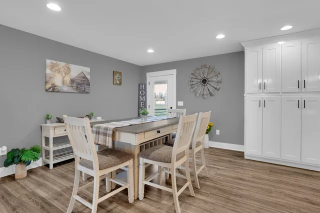 a view of a dining room with furniture and wooden floor