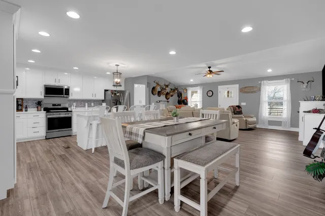 a large kitchen with a table and chairs