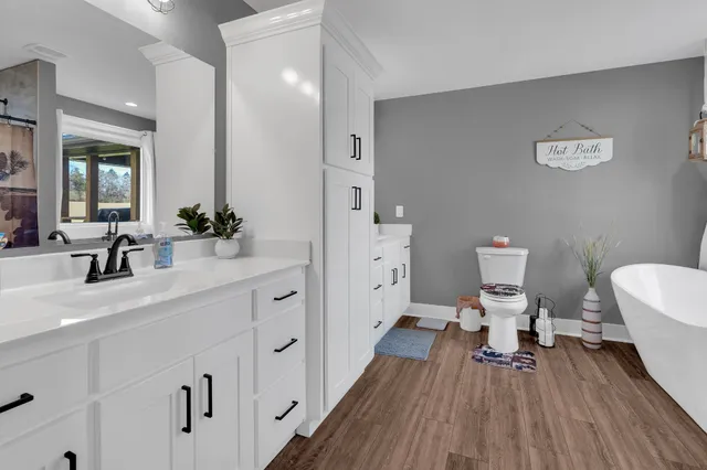 a spacious bathroom with a double vanity sink and a mirror