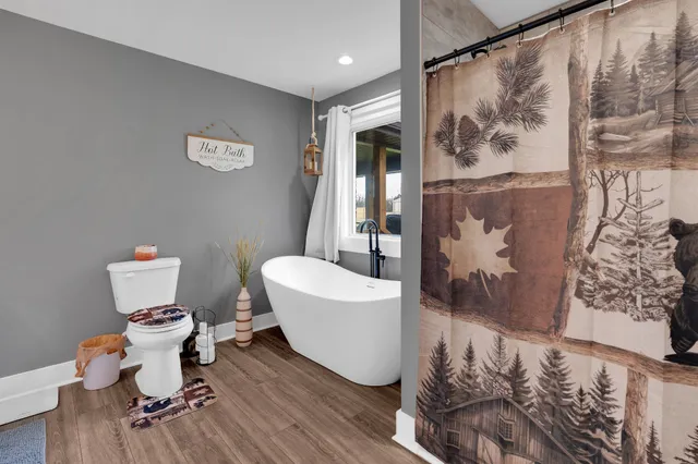 a bathroom with a toilet and a shower