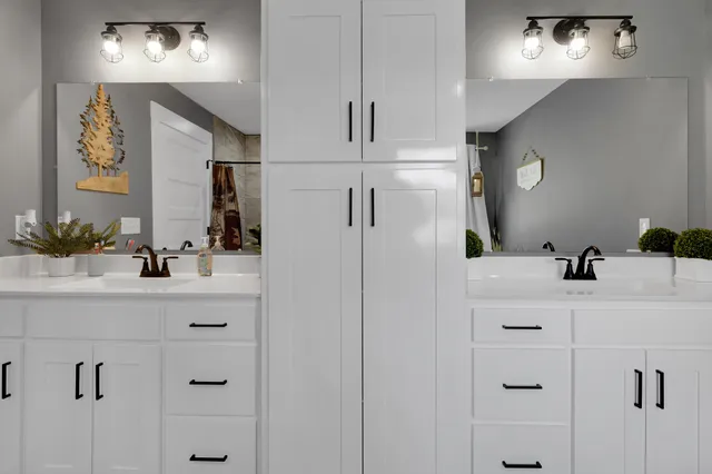 a bathroom with a sink vanity and mirror