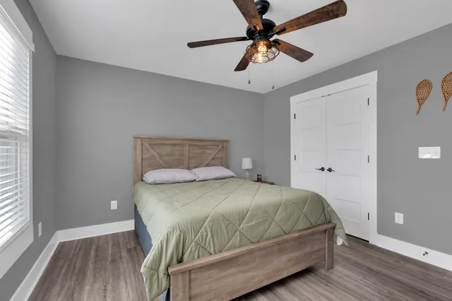 a bedroom with a bed and a chandelier