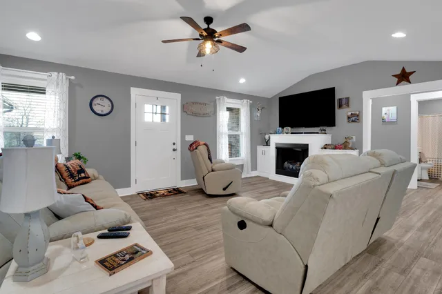 a living room with furniture and a flat screen tv