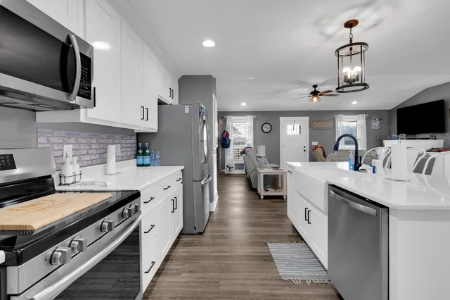 a kitchen with a sink stove and microwave