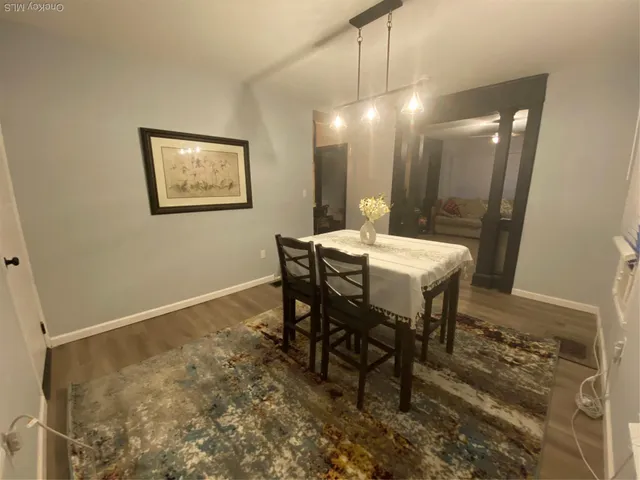 a dining room with a table and chairs