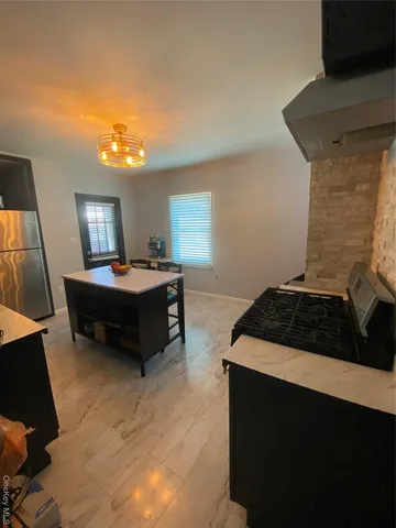 a kitchen with a sink a counter cabinets and appliances