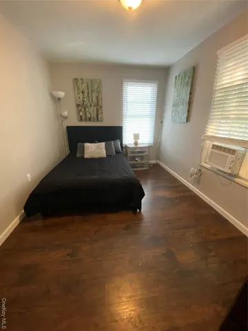 a bedroom with a bed and a night stand