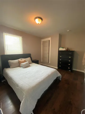 a bed room with a bed furniture and a computer on a desk