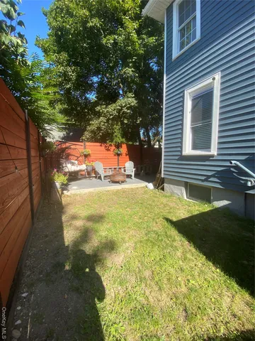 a park view with potted plants and large trees