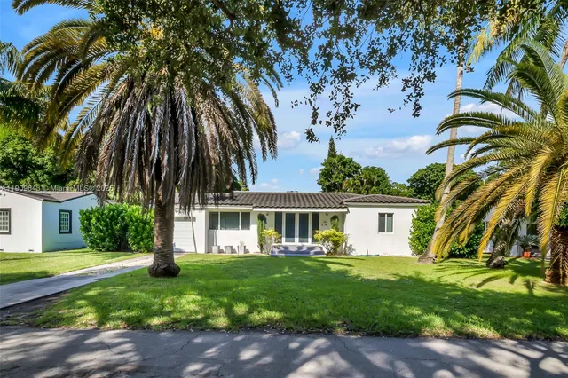 a front view of a house with a garden