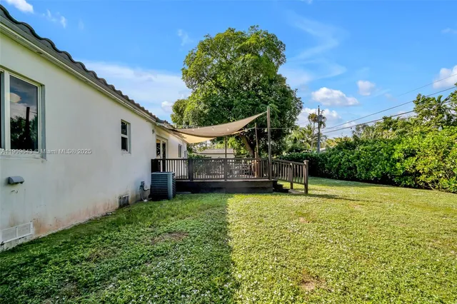 a view of a backyard with plants and a patio