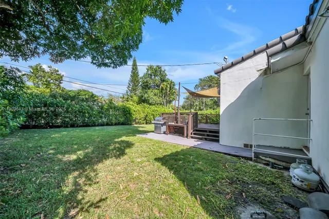 a view of a patio with a table and chairs